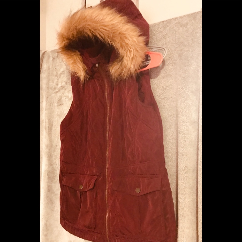 Sleeveless, dark wine colored jacket .